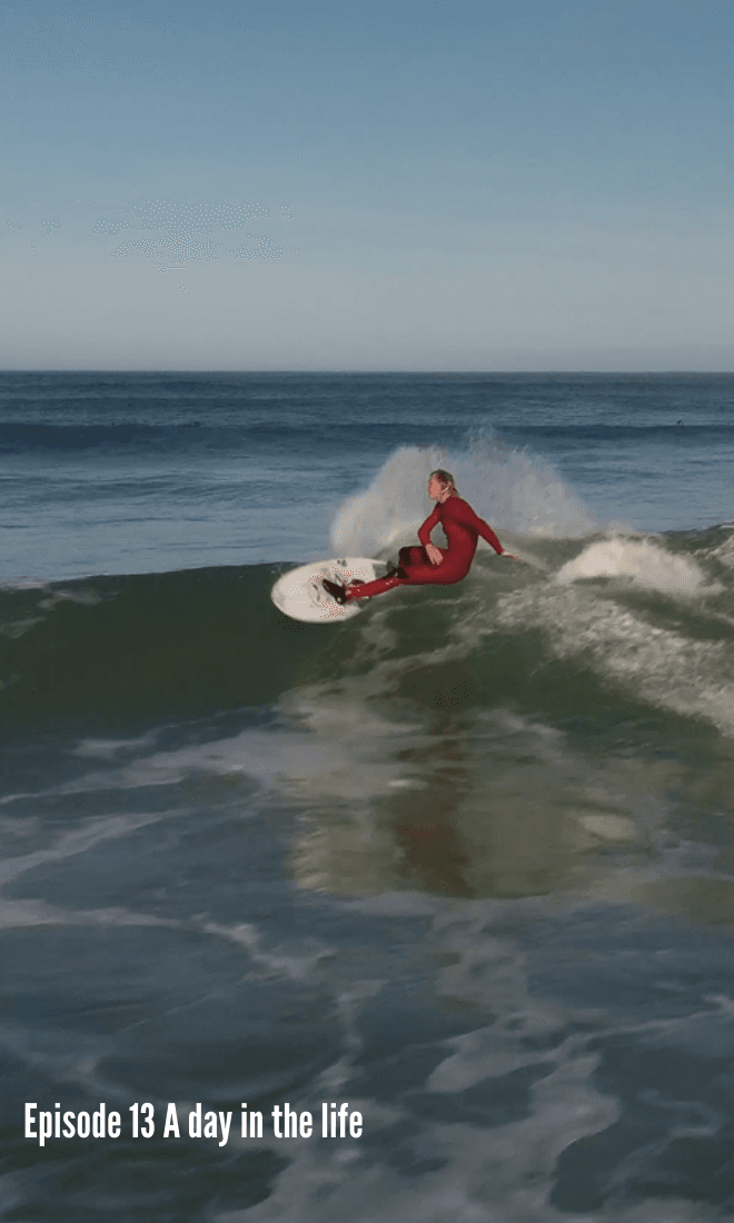 london in red wetsuit suit surfing a wave